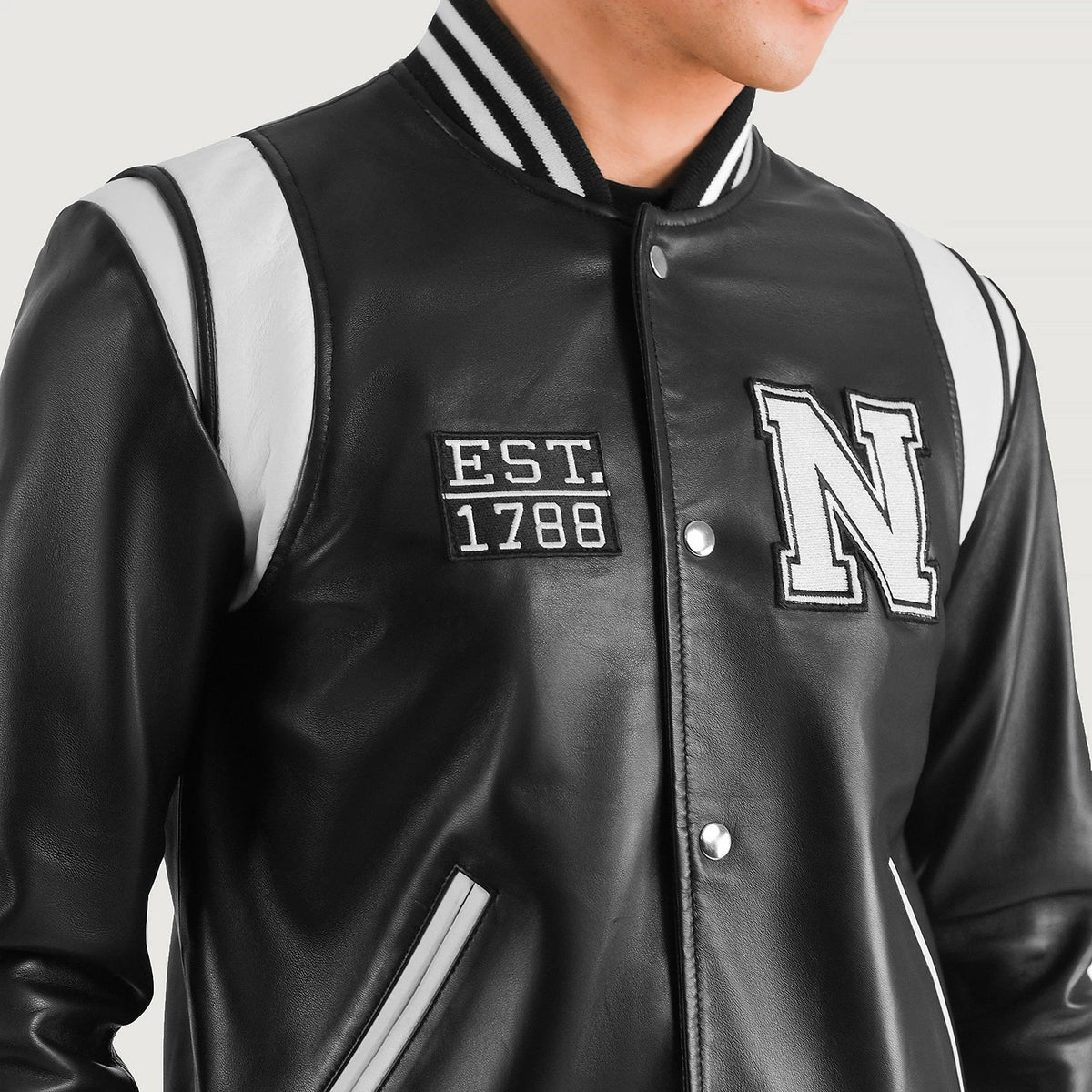 Close-Up Detail of Varsity & Snap Button Hardware on Liberte New York Black Leather Varsity Jacket